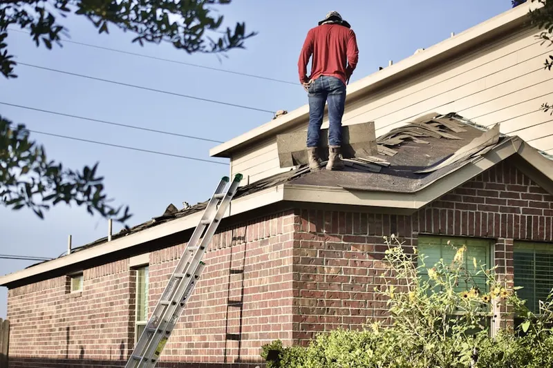 Professional roofer working on a residential roof in Escanaba